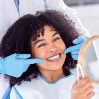 Patient smiling looking in mirror